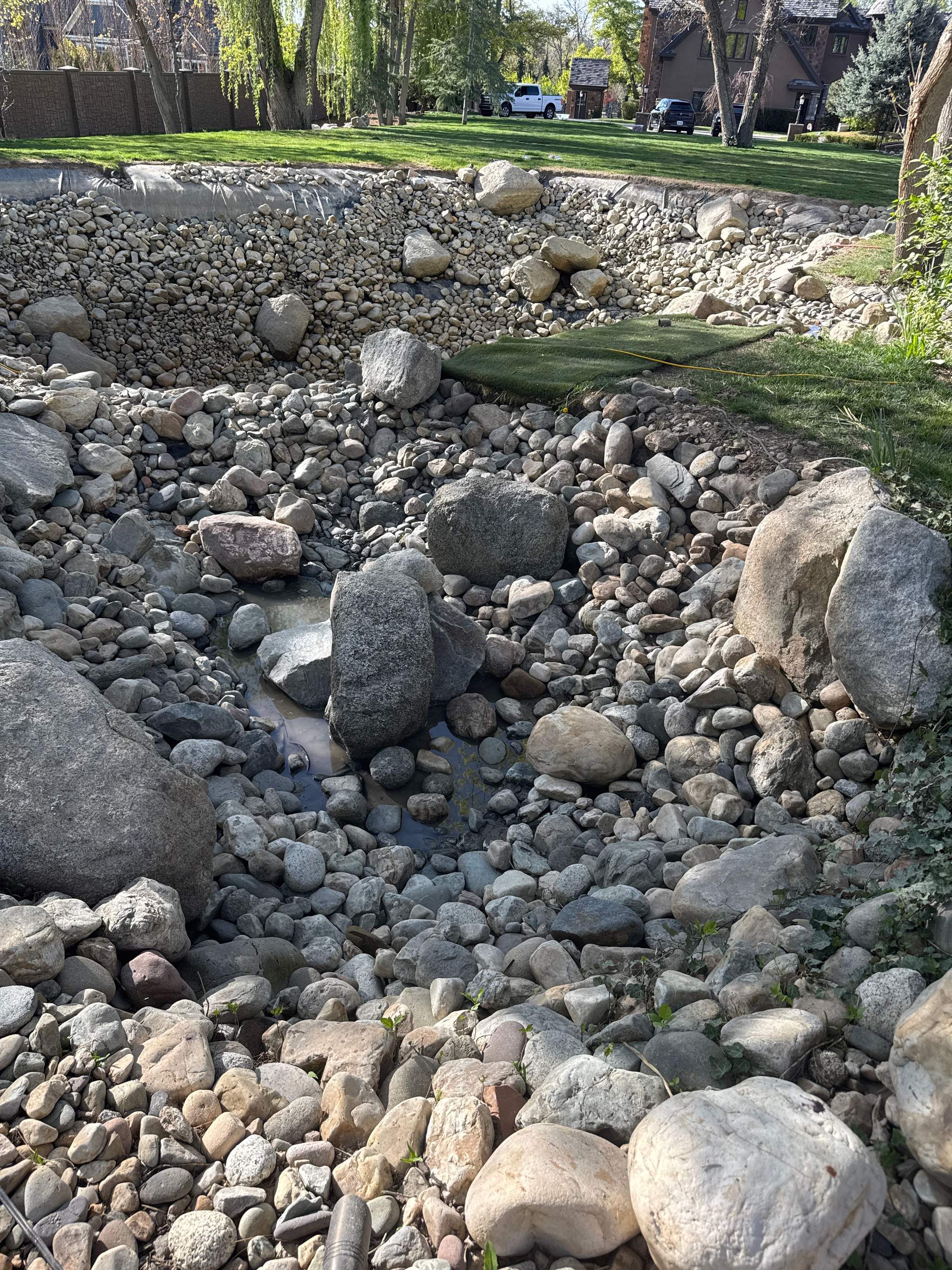 Rock-lined pond fully drained and cleaned by Utah Water Gardens
