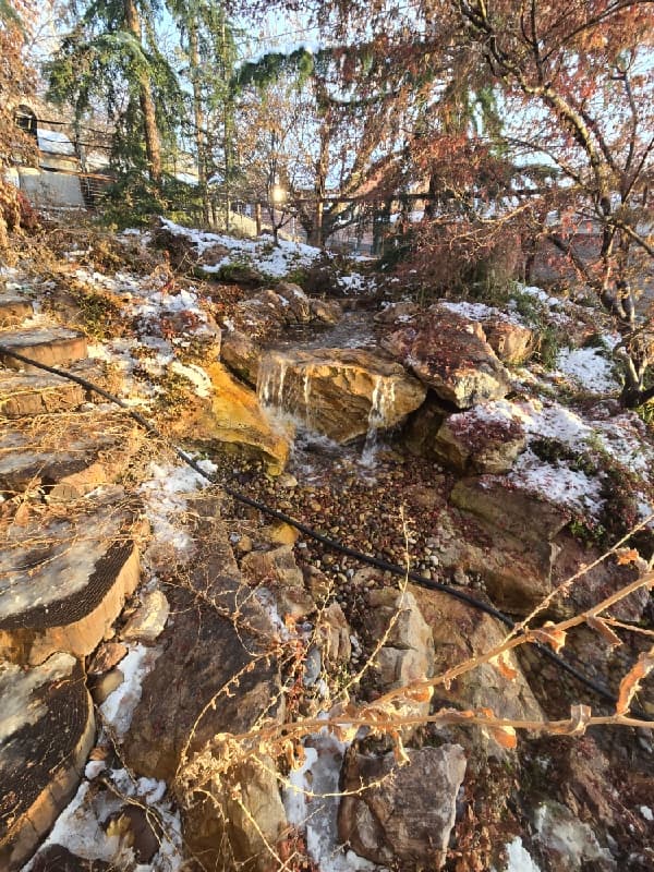 Rock waterfall in the Holladay project with icicles and patches of snow
