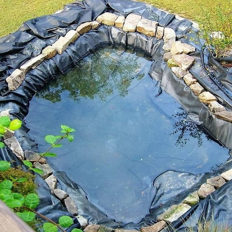 Professional EPDM pond liner installation with underlayment
