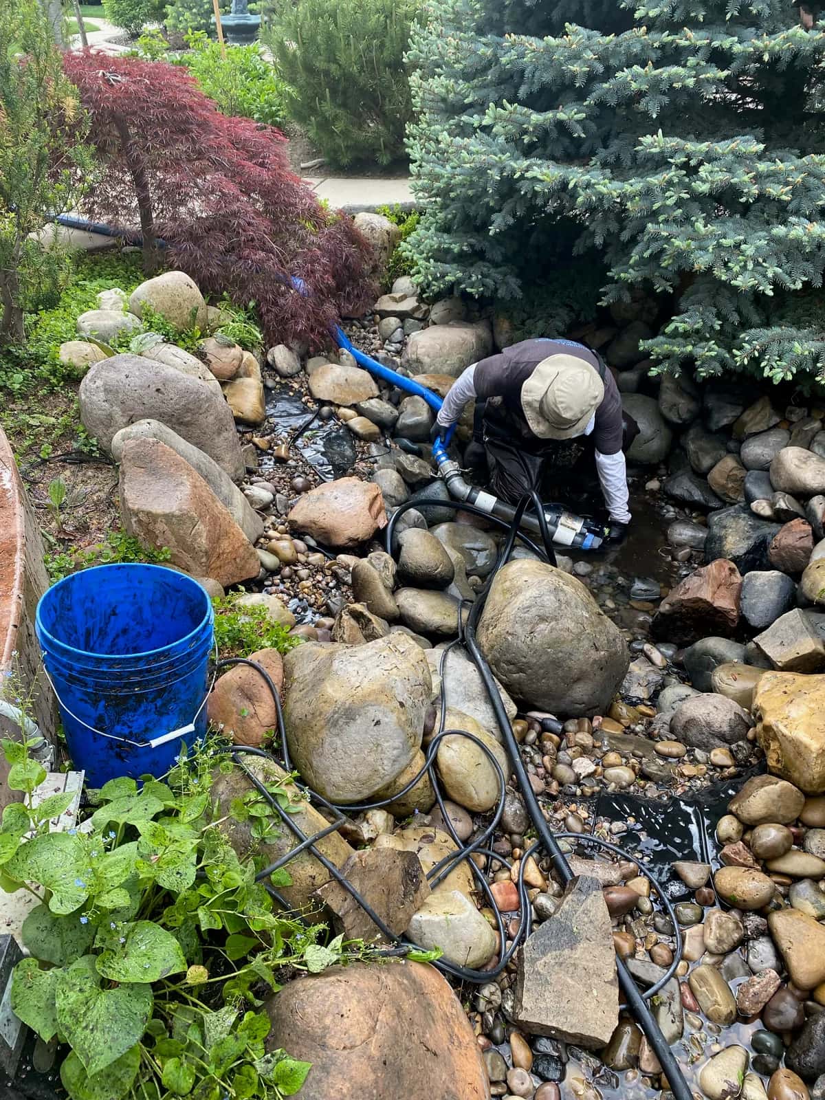 Utah Water Gardens crew cleaning a pond in Salt Lake City Utah