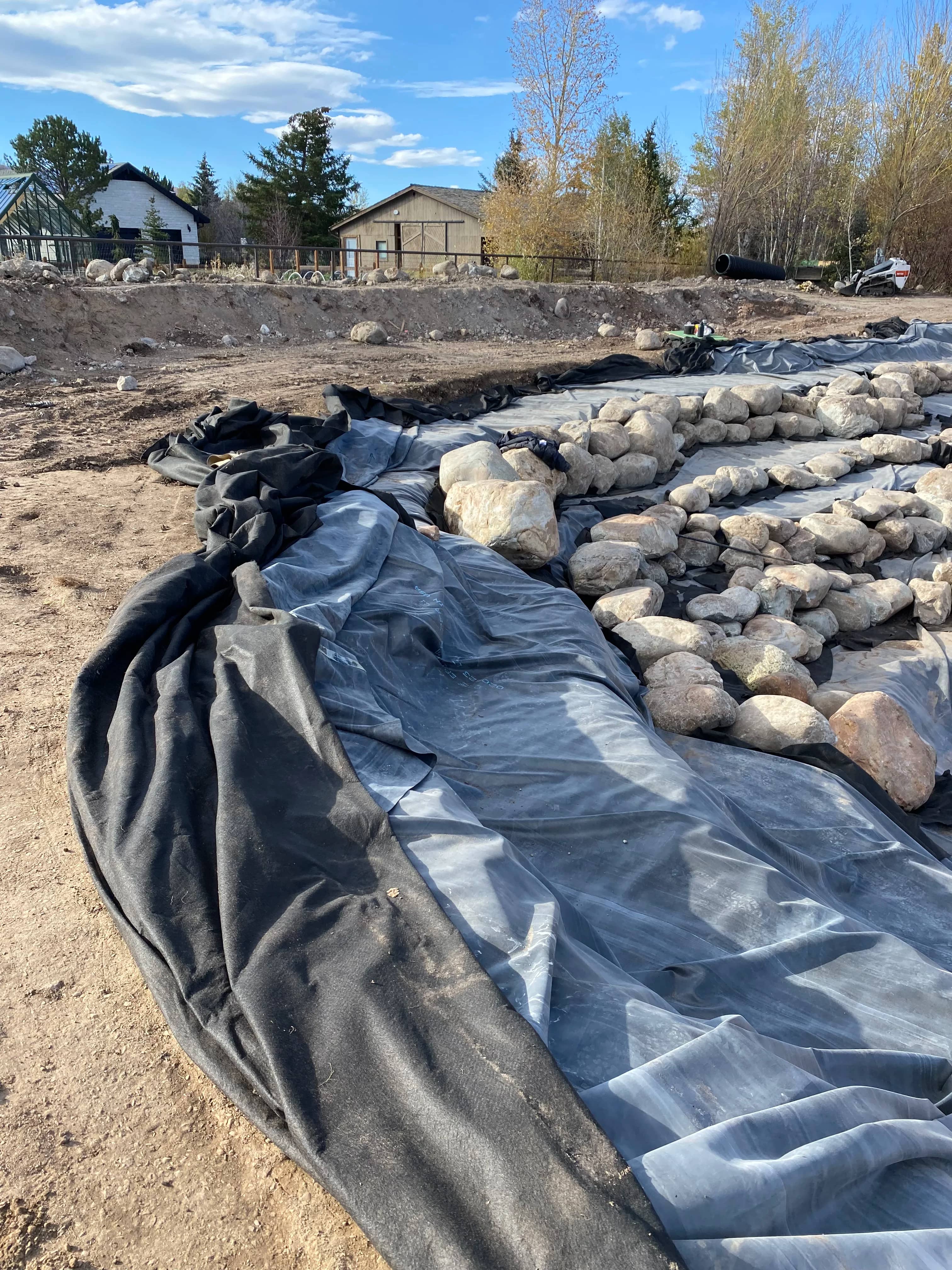 Liner and rockwork installation during pond construction