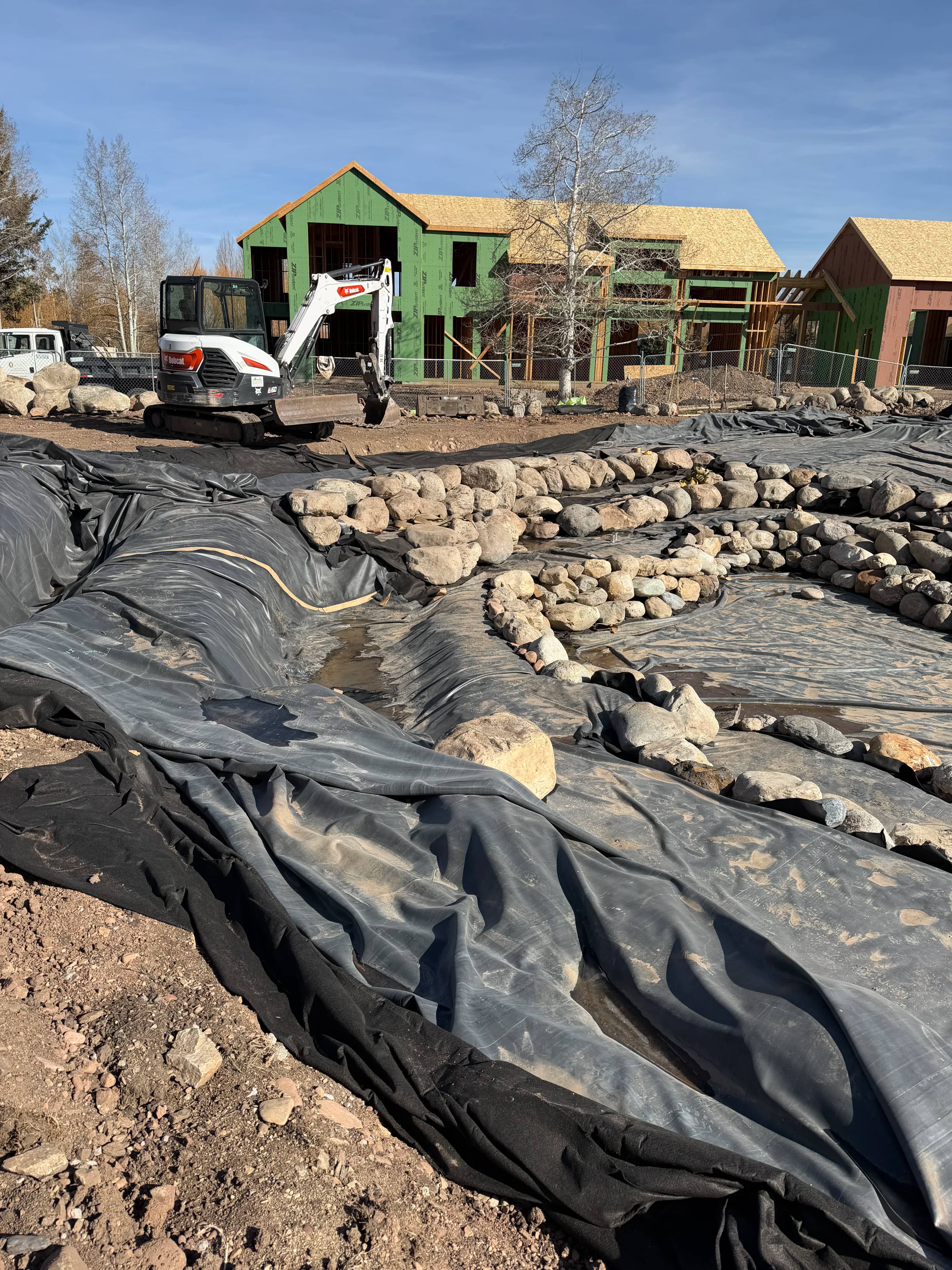 Excavation and shaping in progress during pond construction