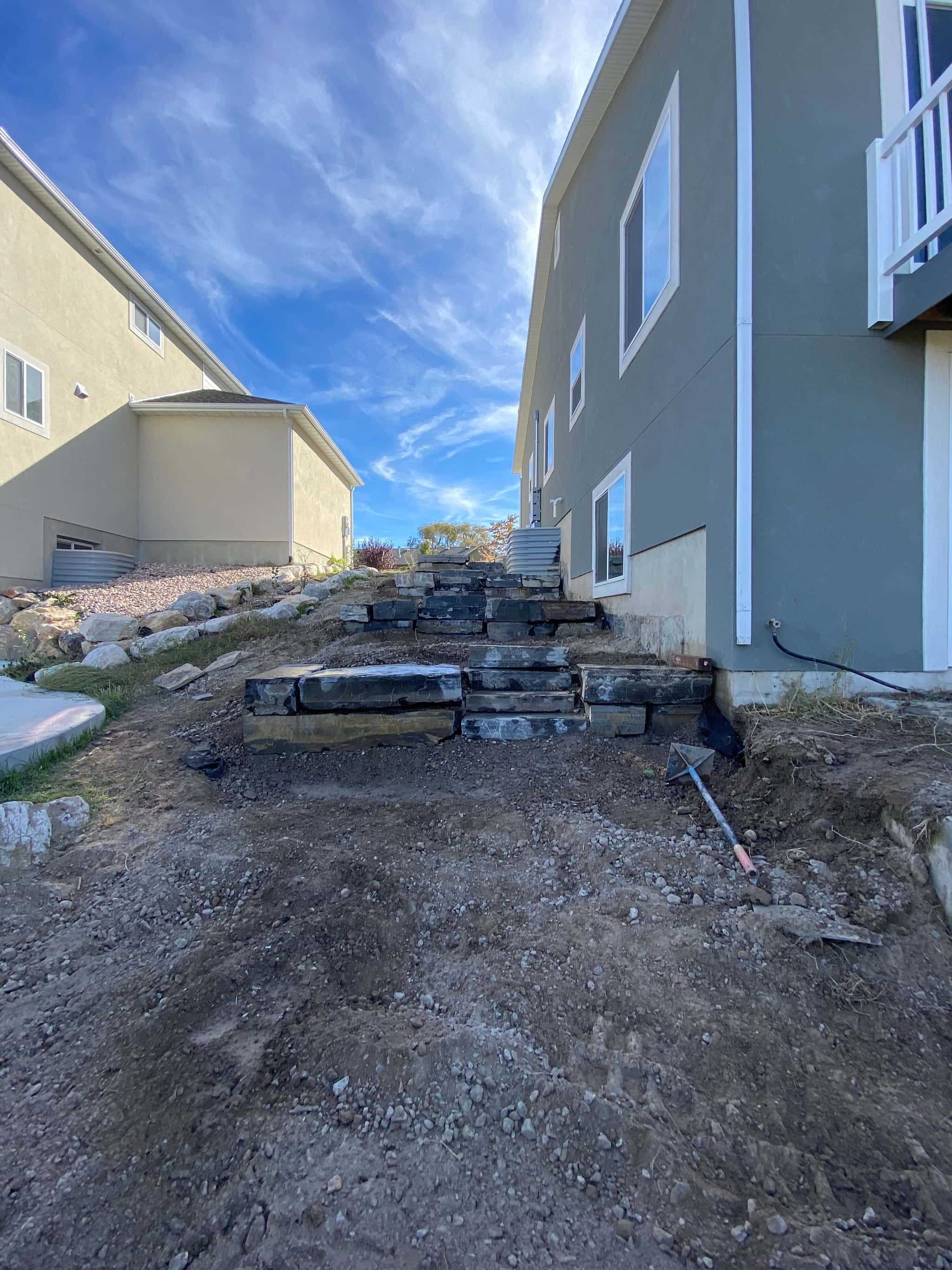 DURING: Professional construction showing rockwork and waterfall installation