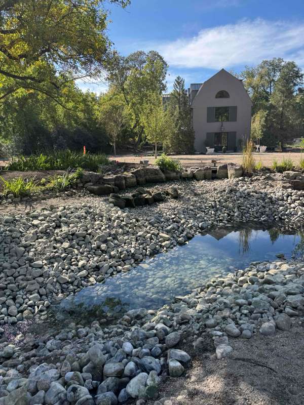 Large rock-lined pond during a multi-day pond cleanout