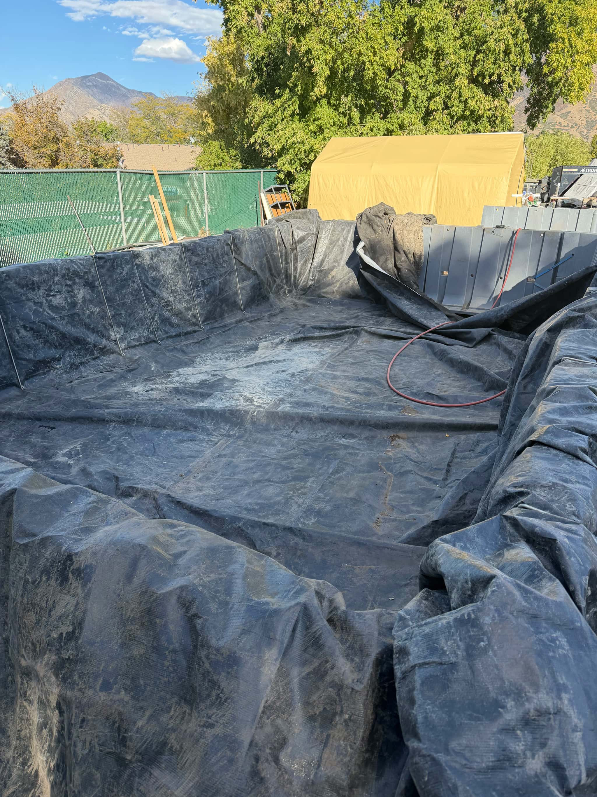 EPDM pond liner installed in a basin prior to leak testing and edge finishing