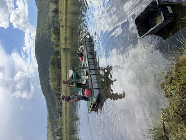 Two crew members working on the floating screening pontoon