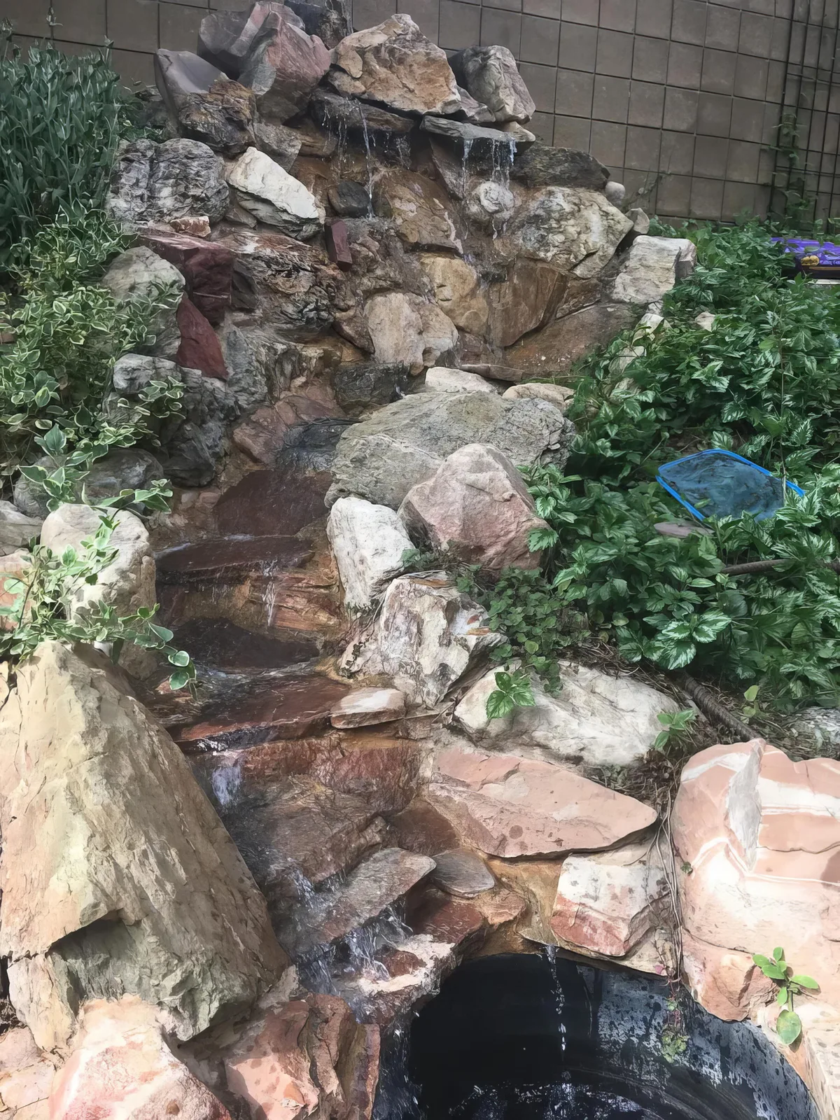 Water feature design with a waterfall and natural rockwork