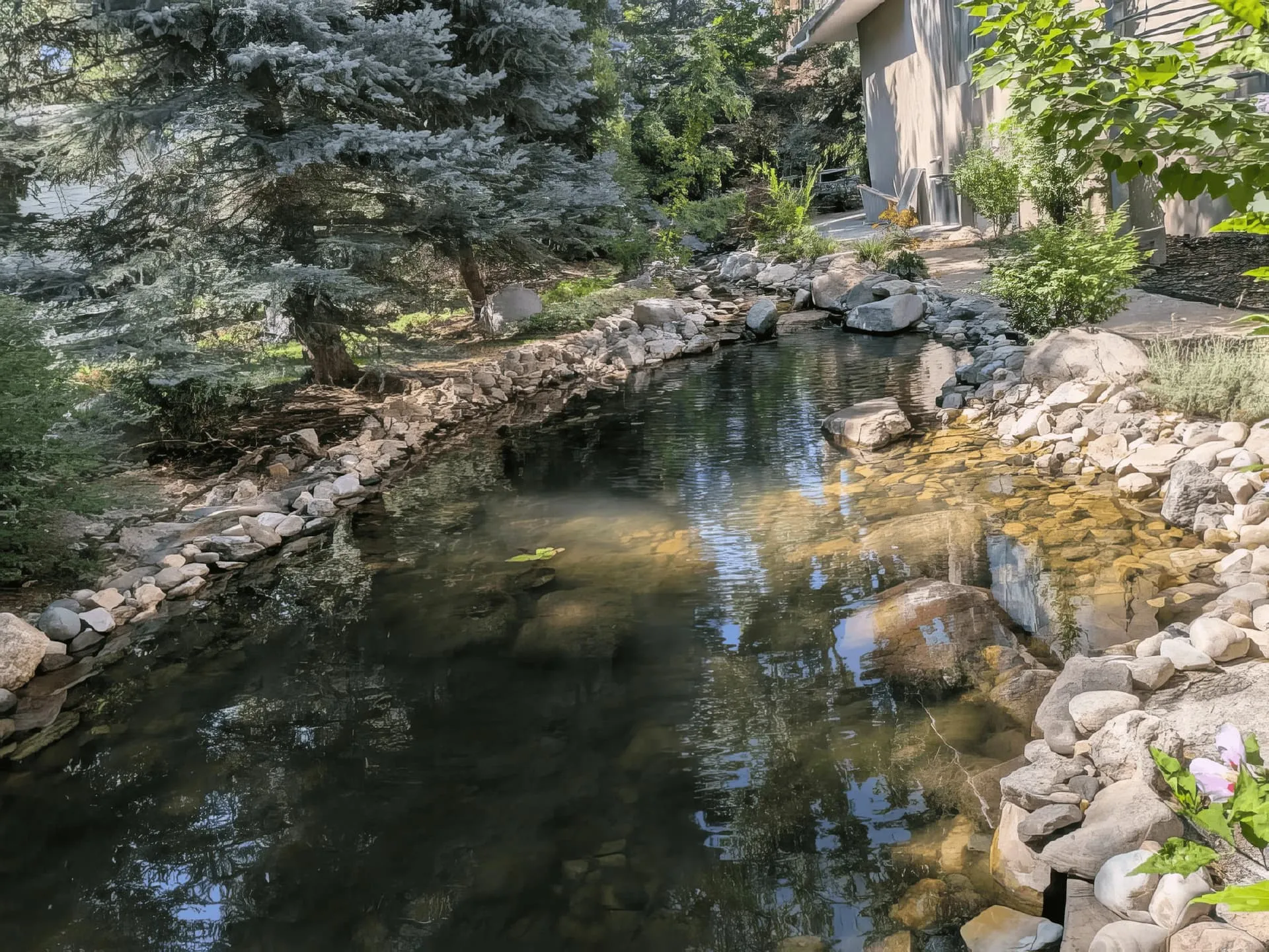 Reflective koi pond with mountain backdrop in Promontory, Park City