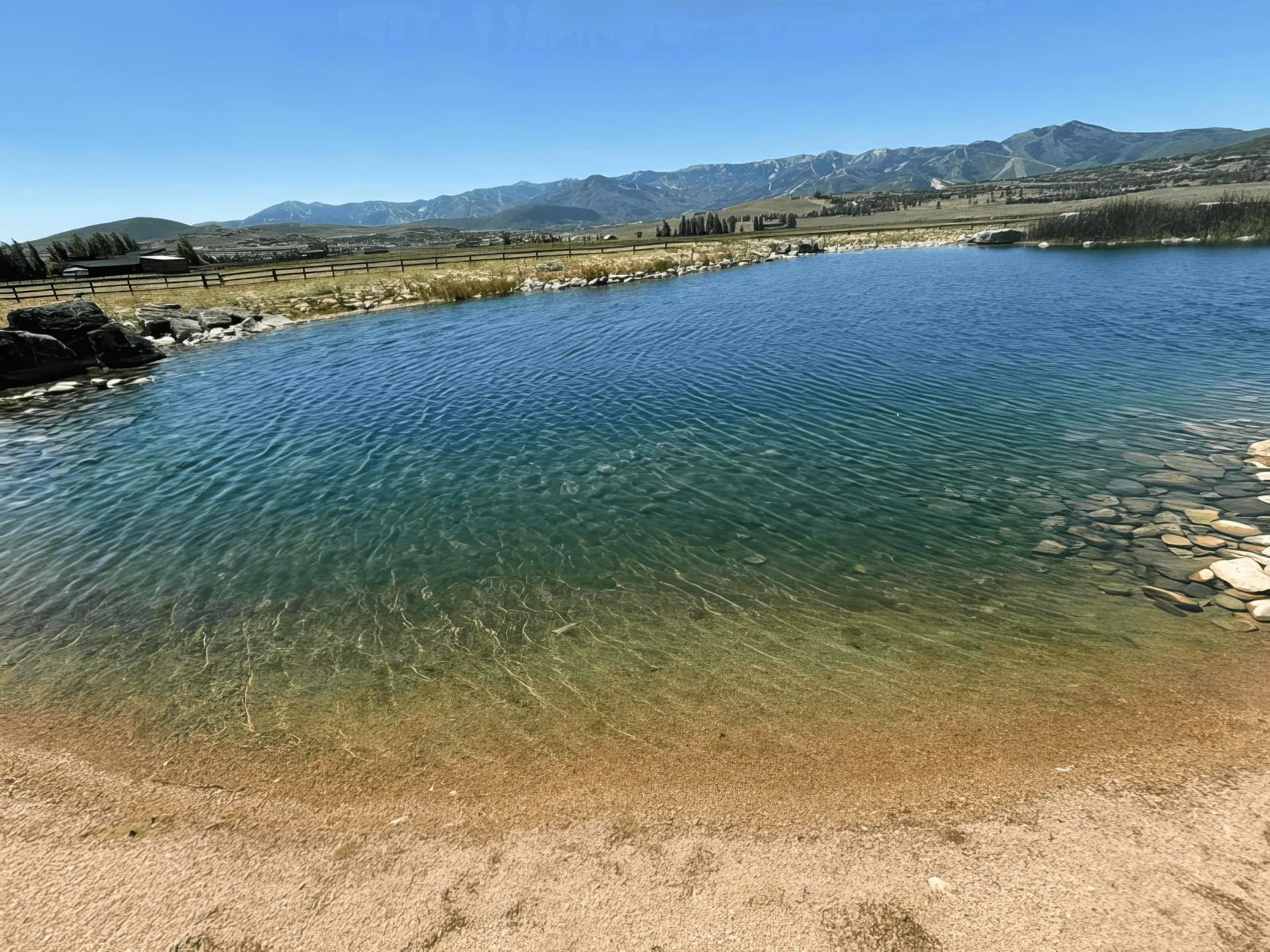 Technicians cleaning a snow-lined pond in Park City