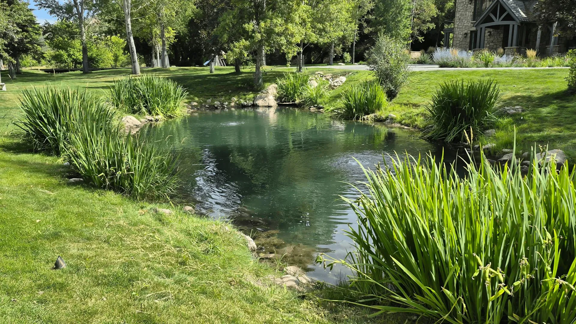 Maintenance technician adjusting pond equipment in Provo